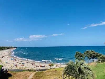 a group of people on a beach with the ocean at Casa Serena in Linguizzetta