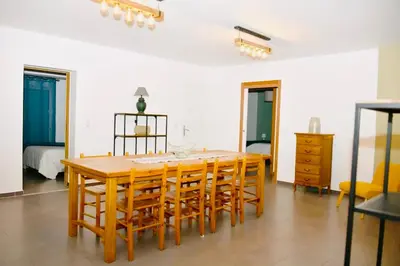 a dining room with a wooden table and chairs at Casa Serena in Linguizzetta