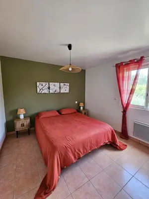 a bedroom with a bed with a red blanket at Casa Marcelli 4 in Porto-Vecchio