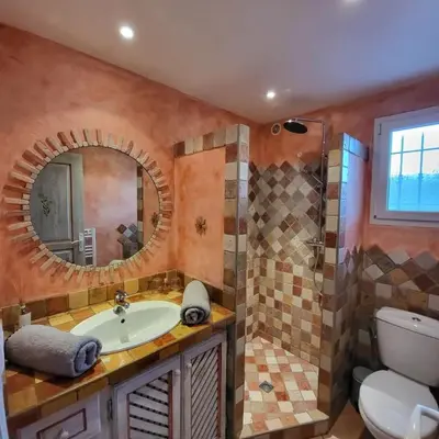 a bathroom with a sink and a toilet and a mirror at Casa Marcelli 4 in Porto-Vecchio