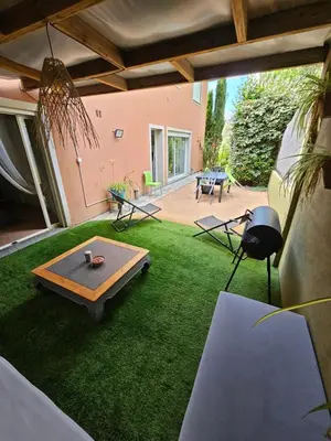 a living room with a ping pong table in the grass at Casa Marcelli 4 in Porto-Vecchio