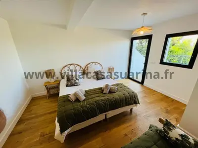 a bedroom with a large bed in a room at Villa vue mer, piscine chauffée à Porto Vecchio in Porto-Vecchio