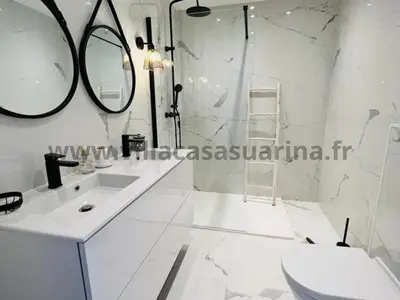 a white bathroom with a sink and a mirror at Villa vue mer, piscine chauffée à Porto Vecchio in Porto-Vecchio