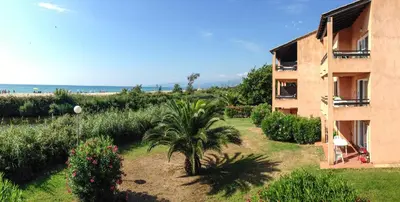 a house with a garden in front of it at Two-room apartment 150 meters from the beach - 4 people - Ghisonaccia in Ghisonaccia