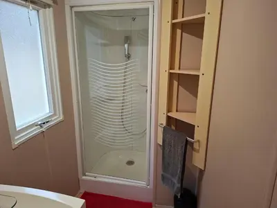 a bathroom with a shower with a glass door at Mira Monti Location in Belvédère