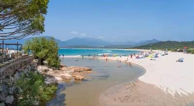a beach with a bunch of people in the water at Mira Monti Location in Belvédère
