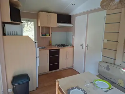 a small kitchen with a table in a small apartment at Mira Monti Location in Belvédère