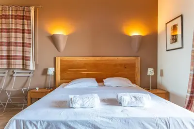 a bedroom with a bed with two pillows on it at Villa Pina in Sainte-Lucie de Porto-Vecchio