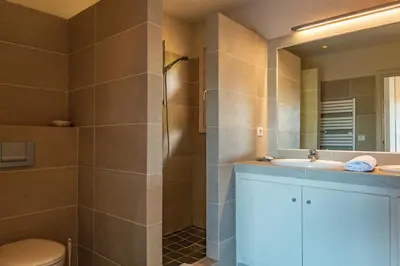 a bathroom with a shower and a sink and a toilet at Villa Pina in Sainte-Lucie de Porto-Vecchio
