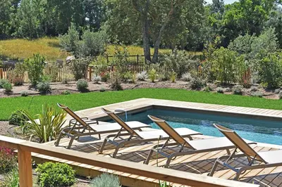 a group of chairs and a swimming pool at Lodge La Myrte Di Lecci in Lecci