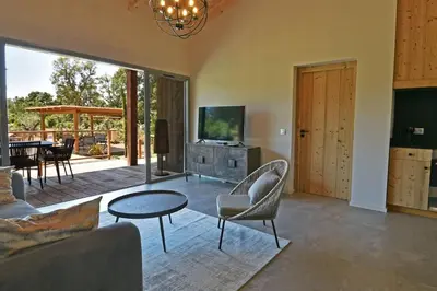 a living room with a couch and a table at Lodge La Myrte Di Lecci in Lecci