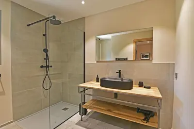 a bathroom with a sink and a shower at Lodge La Myrte Di Lecci in Lecci