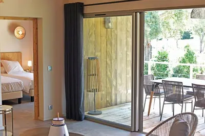 a room with a sliding glass door leading to a bedroom at Lodge Les Arbousiers Di Lecci in Lecci