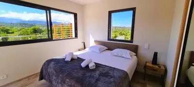a bedroom with a bed with two towels on it at Villa Florida, 8 pers, vue montagne, 350 m plage à pieds in Pinarellu