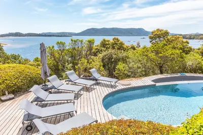 a swimming pool with lounge chairs and a swimming pool at Villa A signoria in Porto-Vecchio
