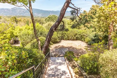 a staircase leading up to a hill with trees at Villa A signoria in Porto-Vecchio