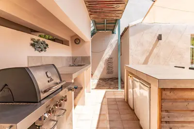 an outdoor kitchen with a stove and a hallway at Villa A signoria in Porto-Vecchio