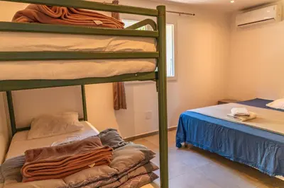 a bedroom with two bunk beds and a bed at Casetta Taglio Rosso Di Santa Lucia in Sainte-Lucie de Porto-Vecchio