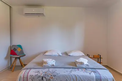 a bedroom with a bed with towels on it at Casetta Taglio Rosso Di Santa Lucia in Sainte-Lucie de Porto-Vecchio