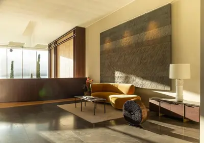 a living room with a yellow chair and a table at Casadelmar in Porto-Vecchio