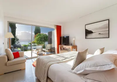 a bedroom with a large bed and a view of the ocean at Casadelmar in Porto-Vecchio