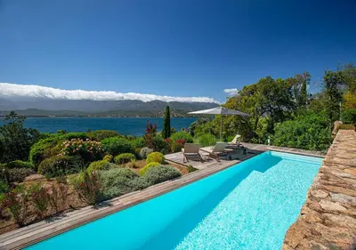 a swimming pool with a view of the water at Casadelmar in Porto-Vecchio
