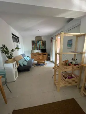 a living room with a couch and a table at Appartement meublé Porto vecchio in Porto-Vecchio