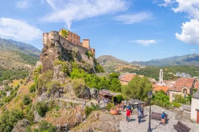 a castle on the top of a mountain at Corte tres beau T2 neuf hyper centre 4 personnes calme et lumineux wifi lave linge in Corte