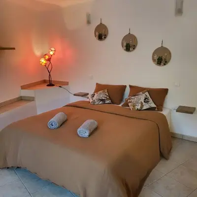 a bedroom with a large bed with two pillows on it at Casa Marcelli 3 in Porto-Vecchio