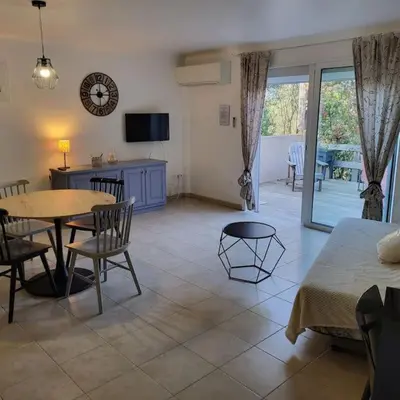 a living room with a table and a table and chairs at Casa Marcelli 3 in Porto-Vecchio