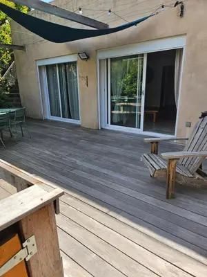 a wooden deck with two chairs and a table at Casa Marcelli 3 in Porto-Vecchio