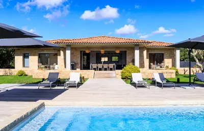 a villa with a swimming pool and a house at A Liccia in Pianottoli-Caldarello