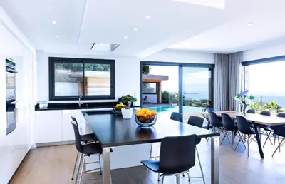 a kitchen and dining room with a table and chairs at Villa Supranu in Viggianello