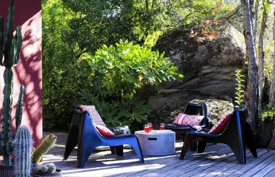 a patio with two chairs and a table and a cactus at Villa Bule in Porto-Vecchio