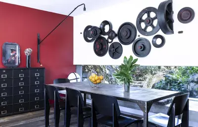 a dining room with a black table and black chairs at Villa Bule in Porto-Vecchio