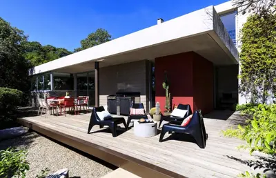 a deck with chairs and a table on a house at Villa Bule in Porto-Vecchio