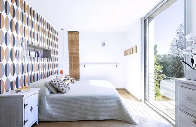 a bedroom with a bed and a large window at Villa Bule in Porto-Vecchio