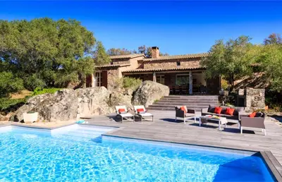 a villa with a swimming pool and a house at I Vaddi in Porto-Vecchio