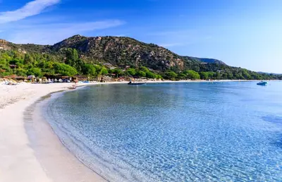 a view of a beach with mountains in the background at I Vaddi in Porto-Vecchio