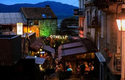 a group of people walking down a street at night at I Vaddi in Porto-Vecchio