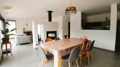 a dining room with a wooden table and chairs at Villa U Scopu, 6 pers, piscine chauffée, 10 mn plage en voiture in Lecci