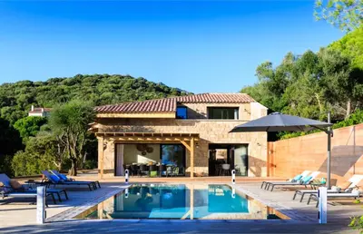 a villa with a swimming pool and a house at The Beach House in Olmeto