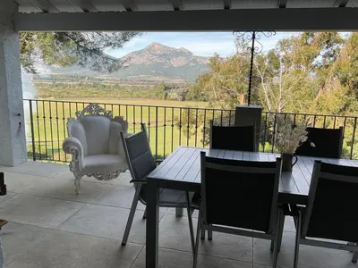 a patio with a table and chairs and a view of a mountain at Fiore di Machja - Moncale in Moncale
