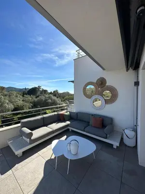a living room with a couch and a table on a balcony at Domaine d'Arca - Aragon 12 - 4 pers in Porto-Vecchio