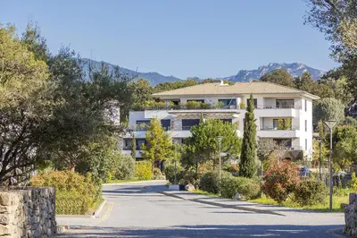 a large white building on a road at Domaine d'Arca - Aragon 12 - 4 pers in Porto-Vecchio