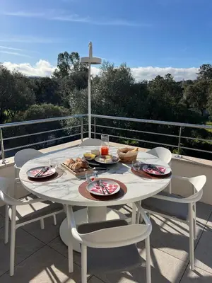 a table with plates of food on a balcony at Domaine d'Arca - Aragon 12 - 4 pers in Porto-Vecchio