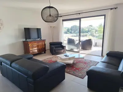 a living room with a couch and a tv at Domaine d'Arca - Flaubert 10 - 4 pers in Porto-Vecchio