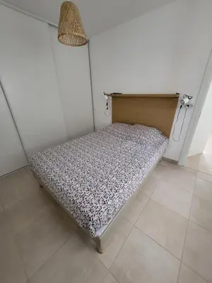 a small bed in a corner of a room at Residence Marina di Bravone in Linguizzetta