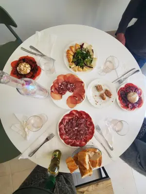 a white table with plates of food on it at Residence Marina di Bravone in Linguizzetta