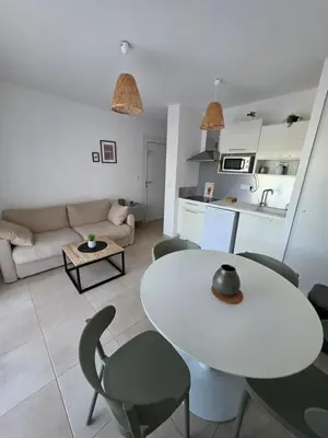 a living room with a white table and chairs at Residence Marina di Bravone in Linguizzetta